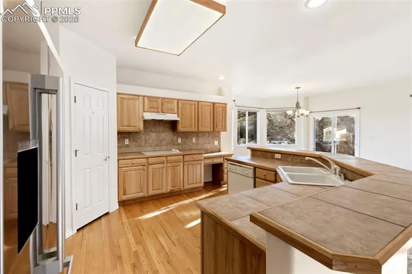 a kitchen with stainless steel appliances granite countertop a sink and cabinets