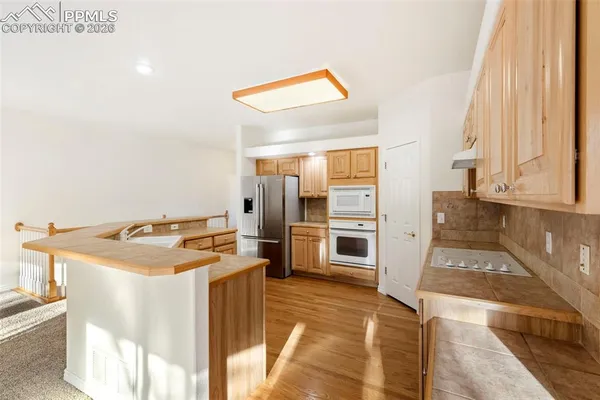 a kitchen with stainless steel appliances granite countertop a stove and a refrigerator