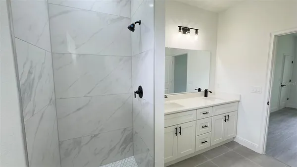 a bathroom with a double vanity sink and mirror