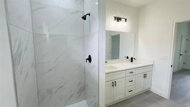 a bathroom with a double vanity sink and mirror