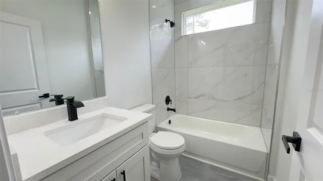 a bathroom with a sink a toilet and a bathtub