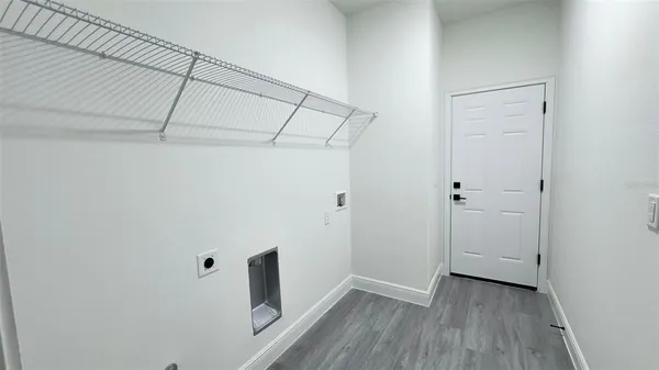 a view of a room with wooden floor