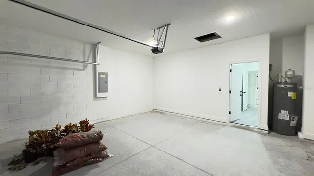 a room with gym equipment and a chandelier