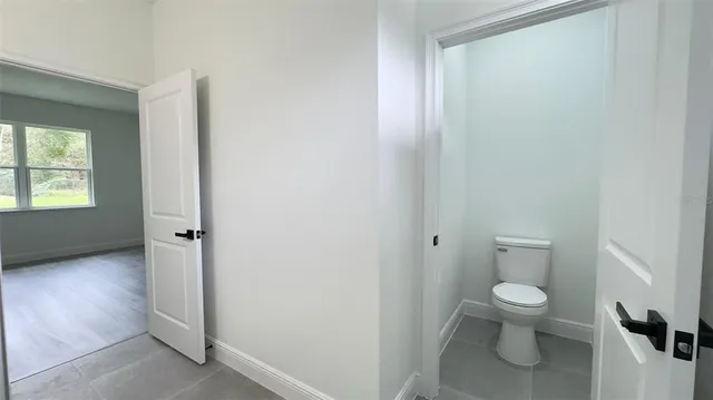 a bathroom with a granite countertop toilet and a sink
