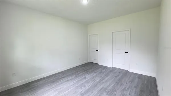 a view of an empty room and wooden floor
