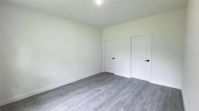 a view of an empty room and wooden floor