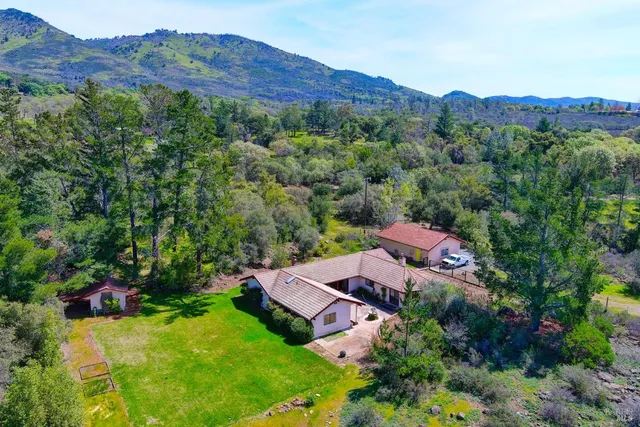an aerial view of a house with outdoor space