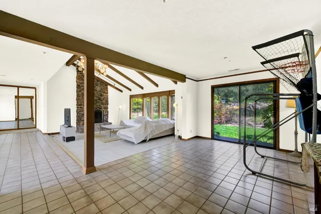 a view of a room with gym equipment and a table