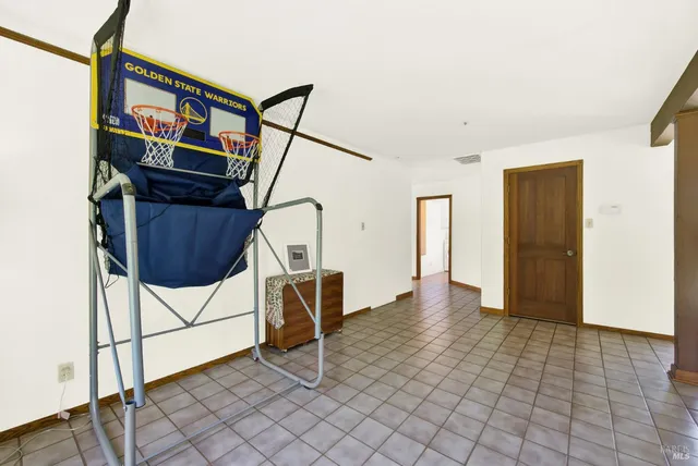 a view of a workspace with furniture and a floor to ceiling window