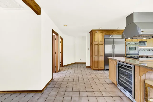 a kitchen with stainless steel appliances a sink stove and cabinets