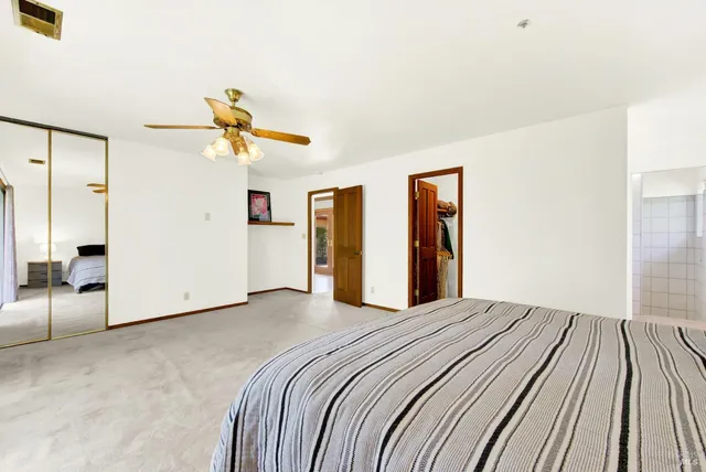 a bedroom with two beds and painted wall