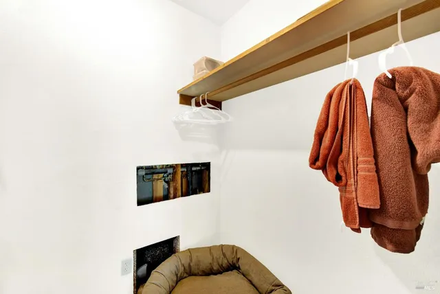 a view of a swimming pool and lounge chairs in back yard