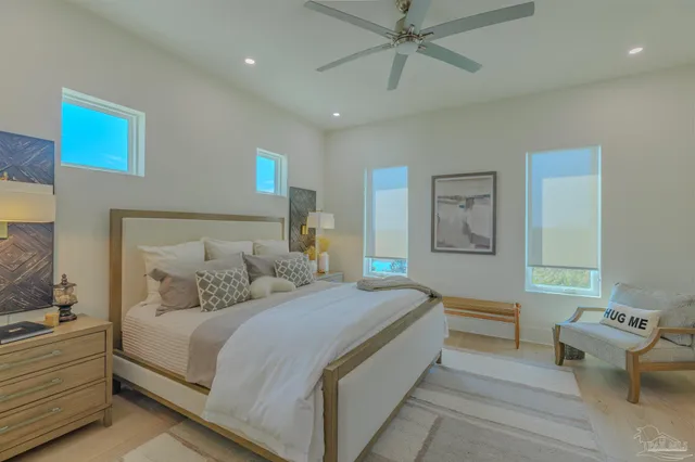 a bedroom with a large bed and a chandelier