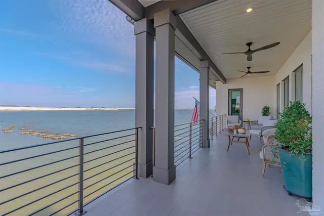a view of a porch with chairs and couches with wooden floor