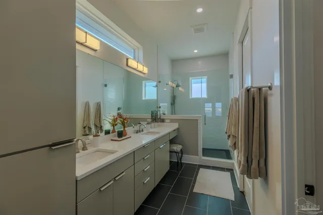 a bathroom with a double vanity sink mirror and shower