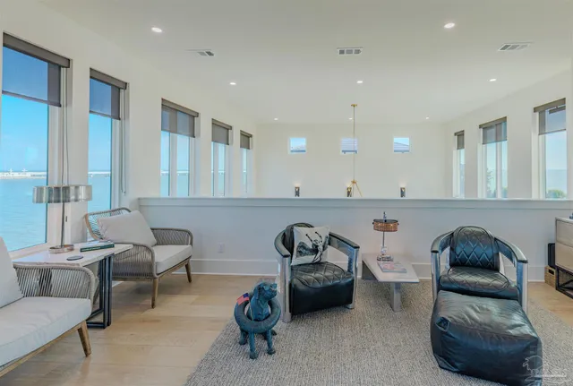 a living room with furniture and a view of kitchen