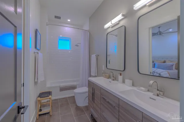 a bathroom with a bathtub shower sink and toilet