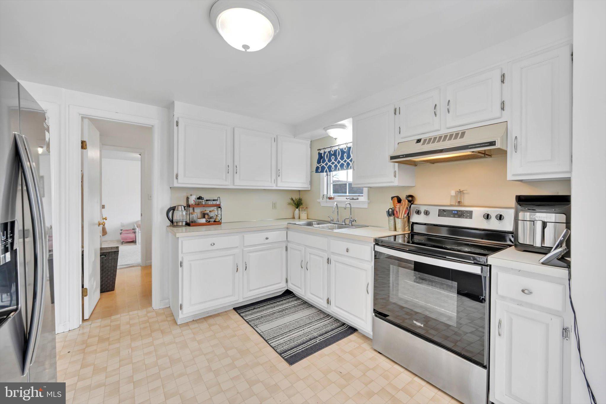 616 Georgetown Road Ronks, PA 17572 - Photo 10 of 35 a kitchen with granite countertop a stove sink and refrigerator