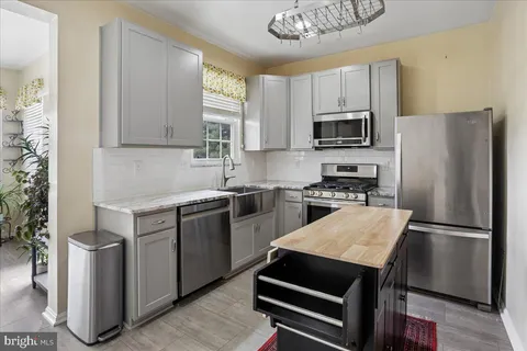 a kitchen with a refrigerator sink and microwave