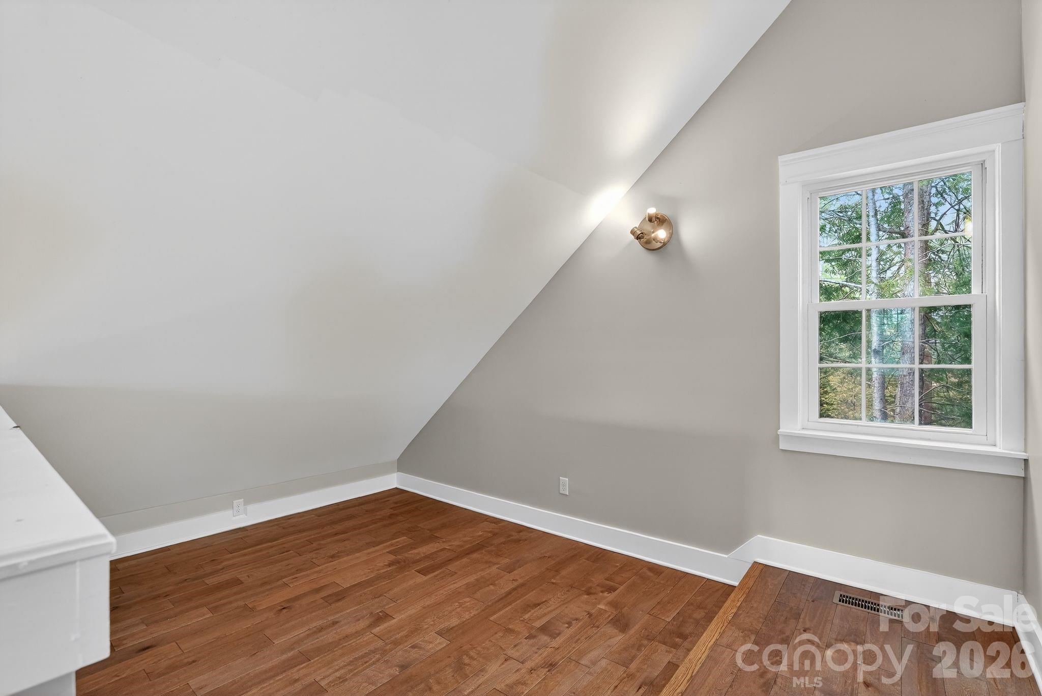 155 North Fork Road Black Mountain, NC 28711 - Photo 14 of 26 an empty room with wooden floor and windows