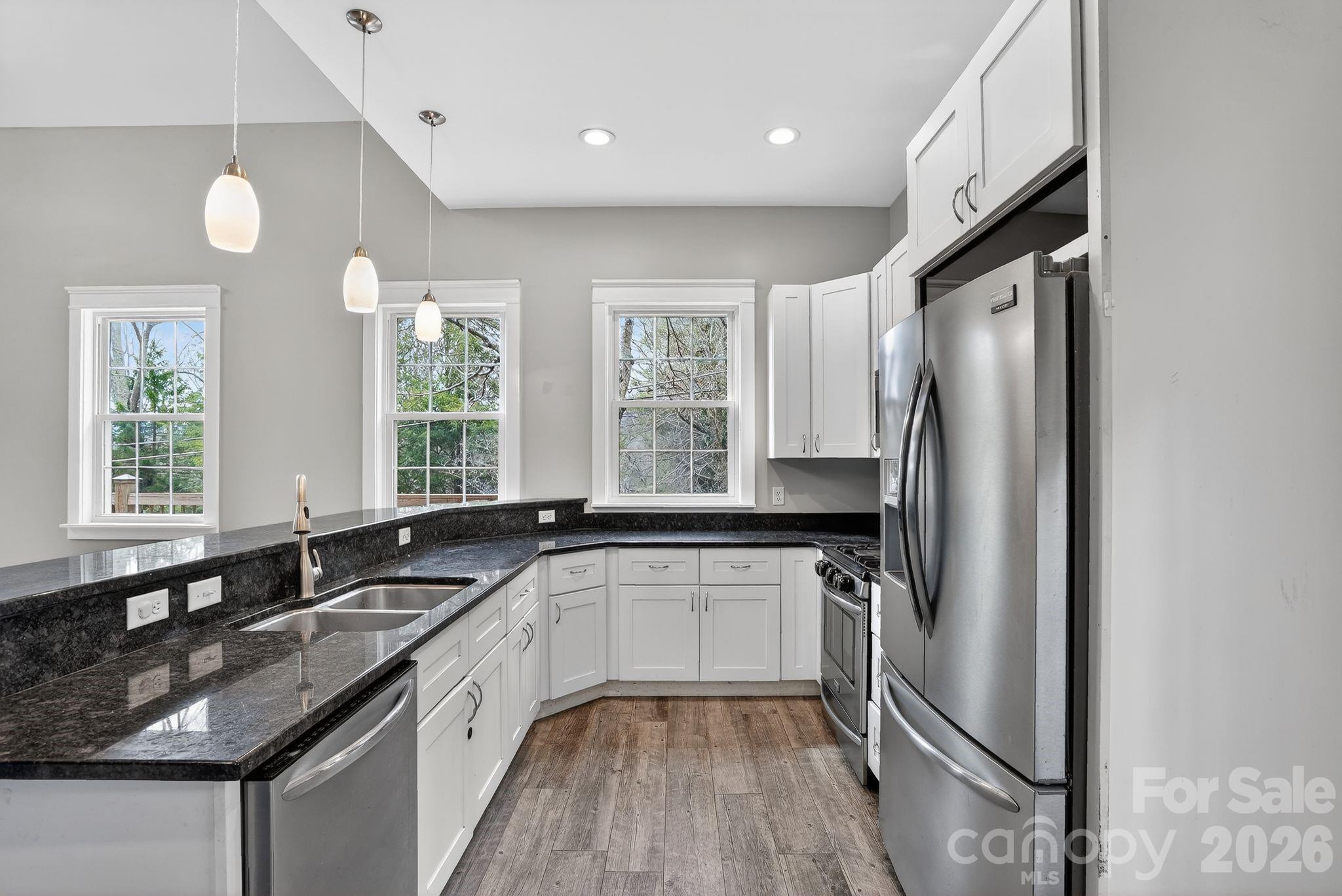155 North Fork Road Black Mountain, NC 28711 - Photo 8 of 26 a kitchen with granite countertop a sink stove and refrigerator