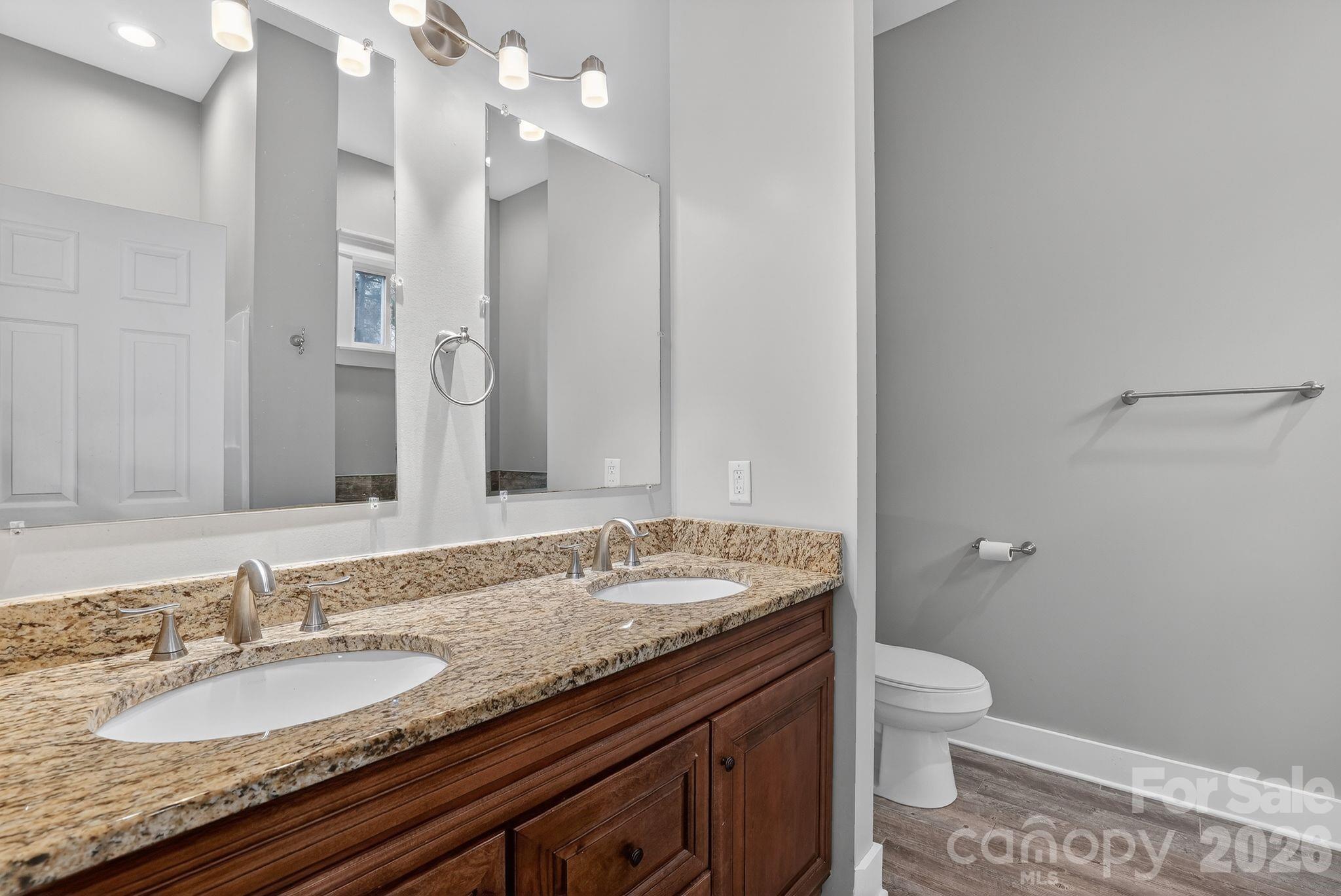 155 North Fork Road Black Mountain, NC 28711 - Photo 10 of 26 a bathroom with a granite countertop sink a toilet and a mirror