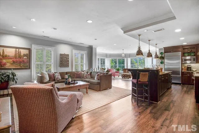 a living room with lots of furniture and wooden floor