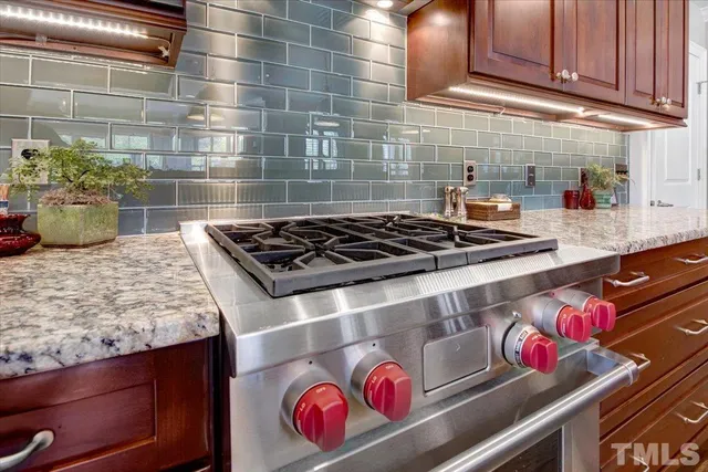 a kitchen with a stove and cabinets