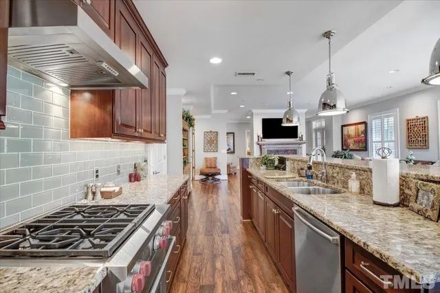 a kitchen with lots of counter top space stove sink and cabinets