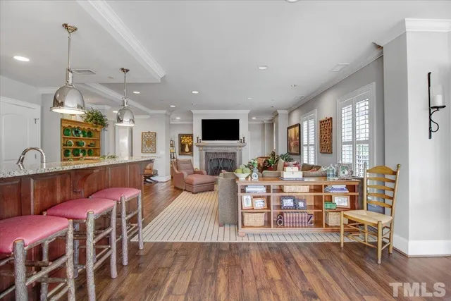 a living room with fireplace furniture and a wooden floor