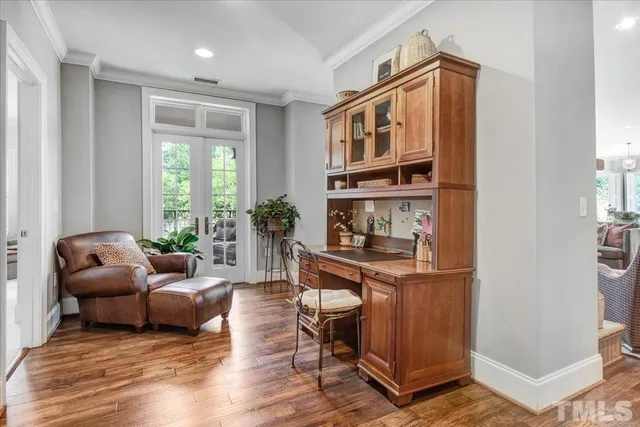 a living room with furniture a window and a potted plant