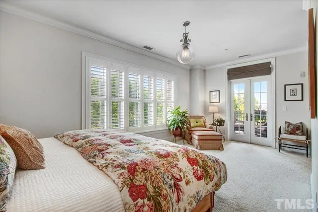 a bedroom with a large bed and a large window