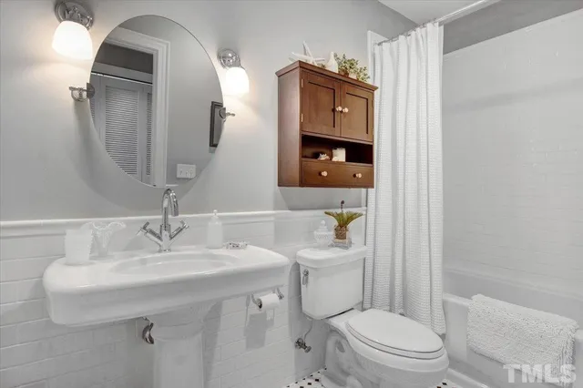 a bathroom with a toilet sink and shower