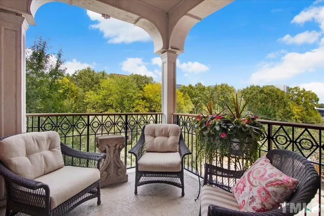 a balcony with furniture and a potted plant