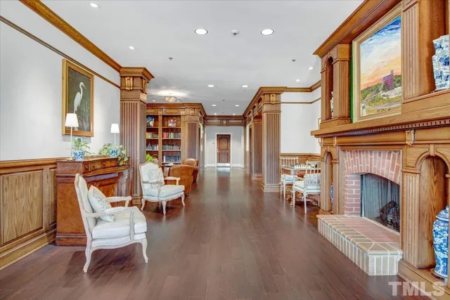 a living room with furniture a fireplace and wooden floor