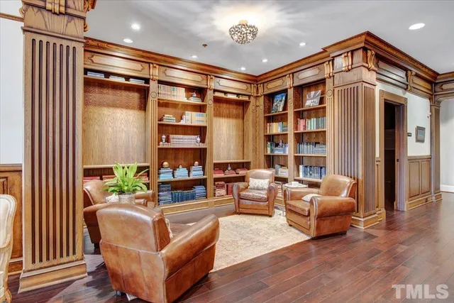 a living room with furniture a lamp and a potted plant
