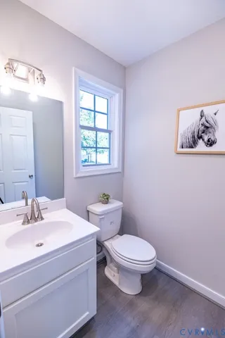 a bathroom with a toilet a sink and a window