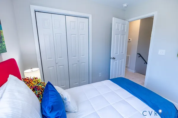a bedroom with a bed and hardwood floor