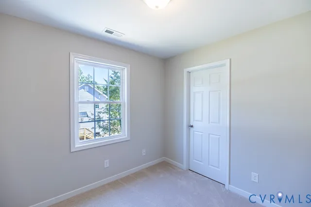 an empty room with windows and closet