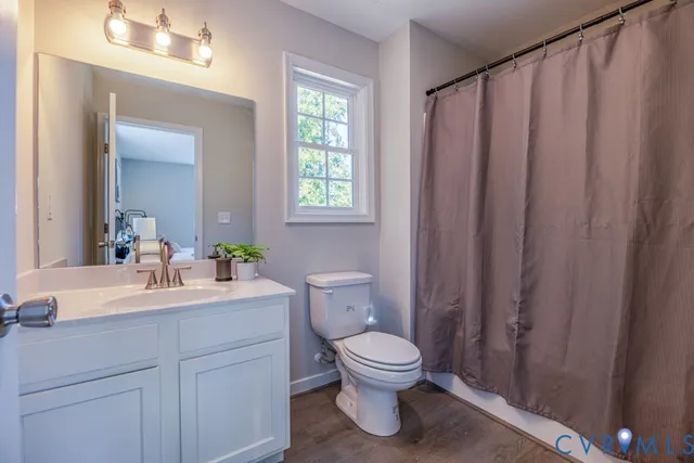 a bathroom with a toilet a sink and a mirror