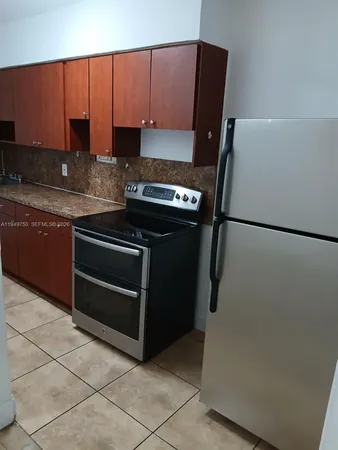 a kitchen with a refrigerator and a sink