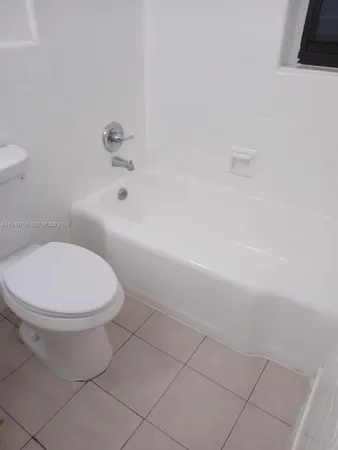 a bathroom with a toilet and a bathtub
