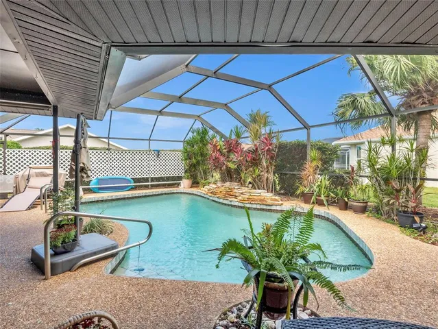 a swimming pool with outdoor seating and yard