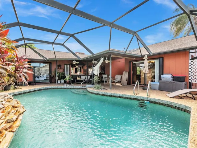 a view of a patio with a table and chairs under an umbrella