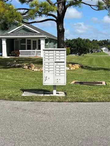 a front view of a house with a yard and lake view
