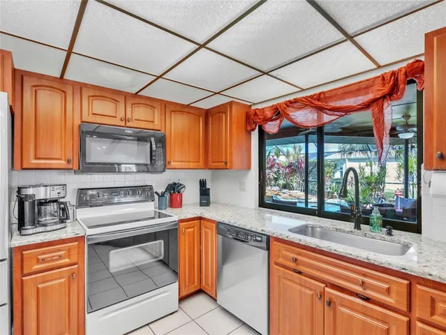a kitchen with stainless steel appliances granite countertop a sink and cabinets