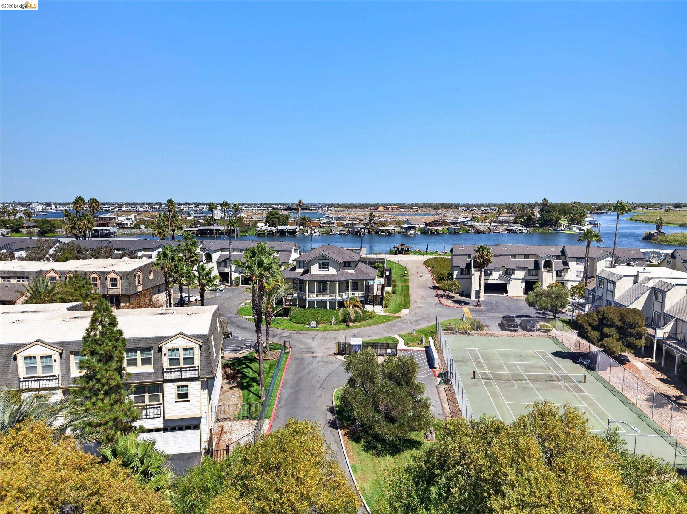 3623 Wells Road Oakley, CA 94561 - Photo 53 of 59 Waterfront community with a large tennis court, mature trees, and paved roadways