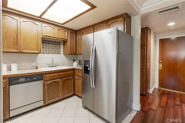 a kitchen with stainless steel appliances granite countertop a refrigerator and a sink