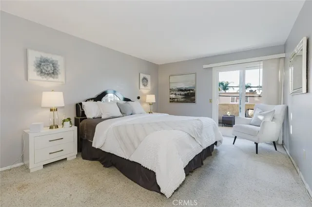 a bedroom with a bed and glass window