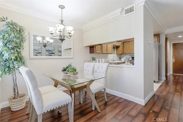 a view of a dining room with furniture wooden floor and chandelier